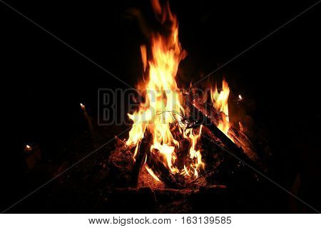 bonfire of logs and firewood at night and candles