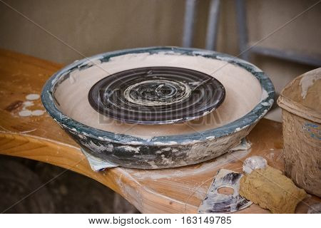 An empty circle where the potter molds product. Creative studio potter. Workplace wizard Crock pottery