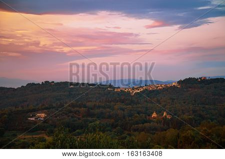 Landscape with a distant greek village at sunset