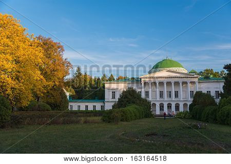 White Sokirinci palace against blue sky background. Ellow trees flavor the composition.