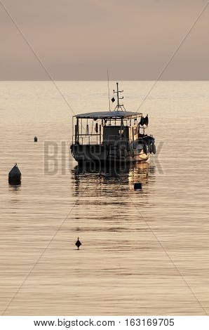 Small fishing boat resting at golden hour