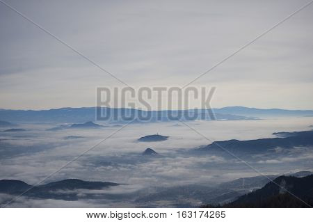 Valley in the mist. View from the mountains.