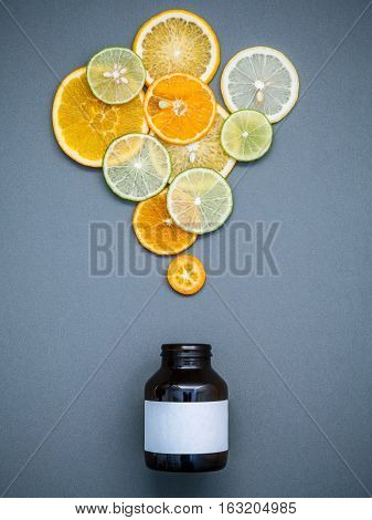 Healthy Foods And Medicine Concept. Bottle Of Vitamin C And Various Citrus Fruits. Citrus Fruits Sli