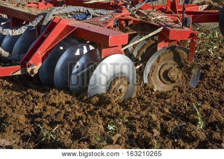 Farm tractor preparing the soil and ranking the field before planting Montijo Badajoz Extremadura Spain