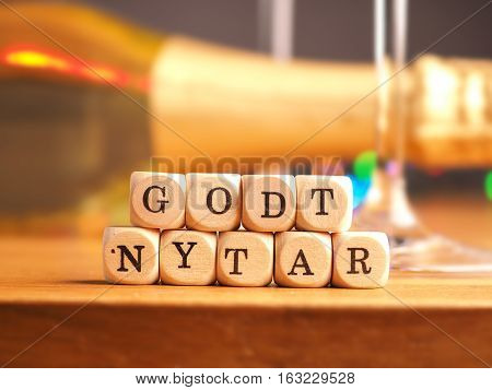 Small wooden dices with the Danish words Godt Nytar Happy New Year background