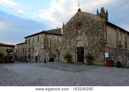 Monteriggioni Italy - September 7 2016: Buildings in Monteriggioni city in Tuscany Italy. Unidentified people visible.