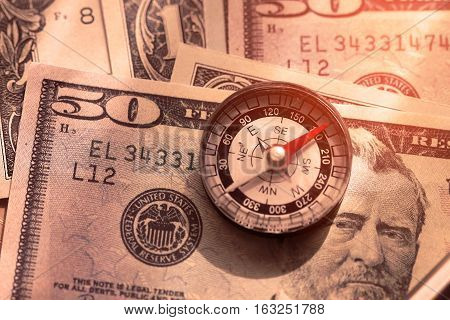 Compass on the banknote concept with the business plan of investment. Business plan for trader or investor by use the compass. Trader planning for use the money in invest.