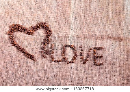 Heart With Roasted Coffee Beans On The Burlap Background