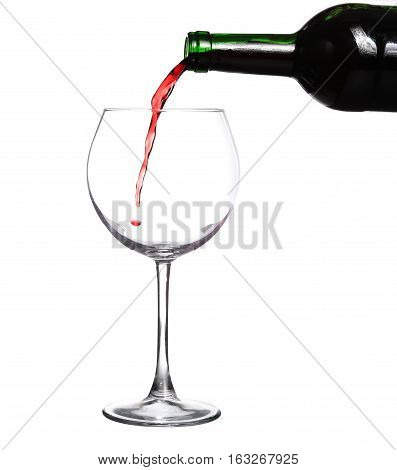 Red wine pouring from boutle on white background