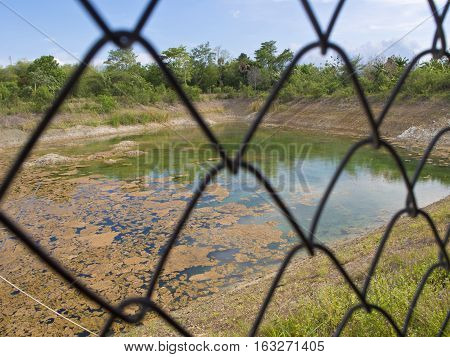 Water pond behind the Steel Grating Fence