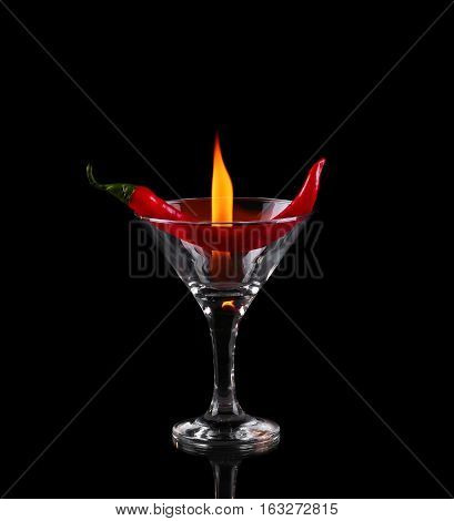 Hot Chili Pepper In A Martini Glass With A Fire On A Black Background