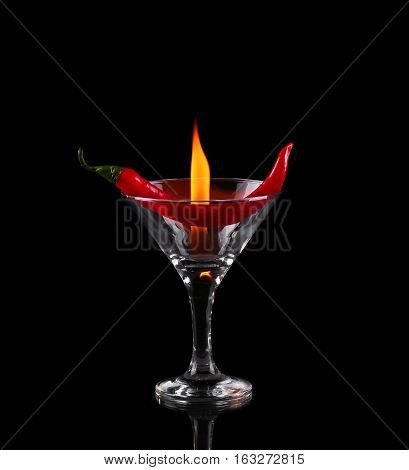 Hot Chili Pepper In A Martini Glass With A Fire On A Black Background