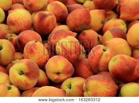 Fresh peaches set together on table at local market