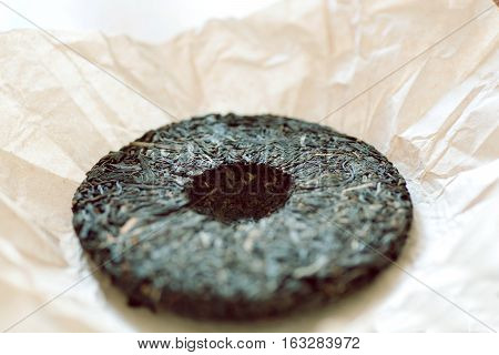 Tea in form of of traditional chinese puer cake. Popular the antioxidant drink from China.