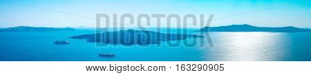 Panoramic bird eye aerial view of white building blue sky and vivid sea in Santorini island Oia Greece