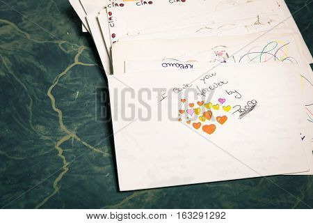 Big stack of mails pile of papers or heap of letters above a letter saying "I love you forever ...".