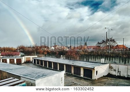 Chomutov Ustecky kraj Czech republic - December 11 2016: garages and road number 13 with clouds and a rainbow on background