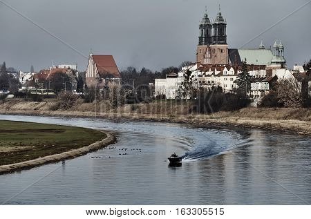 Motorboat and bridge over the river Warta in Poznan