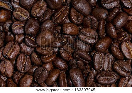 Medium roasted whole coffee beans closeup background
