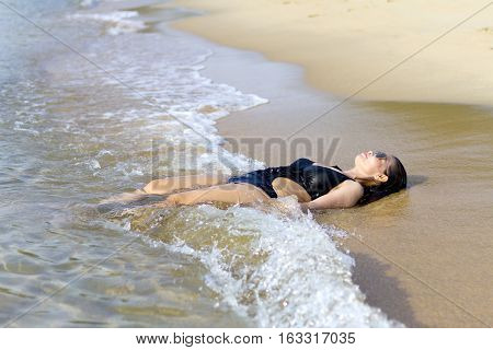 Lady relax on wave swimsuit in Ban Krut Beach at Prachuap Khirikhun Province Thailand