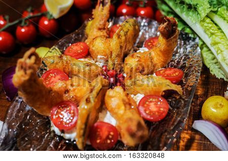 Crispy tempure battered fried prawns served with aubergine, cougterre, tzatziki and pomegranate sauce