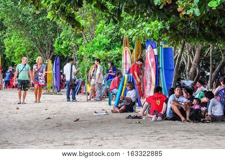 Kuta Beach,Bali,Indonesia-May 28,2010:Local people resting at the ocean beach in Kuta beach,Bali island,Indonesia.Kuta beach is most famous beach in Indonesia among international tourist.
