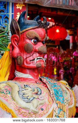 Taiwan - April 30 2016 : God statue in traditional old oriental chinese temple in Taiwan (Chinese Translation on god's strap : mazu temple on couplet : god bless people)