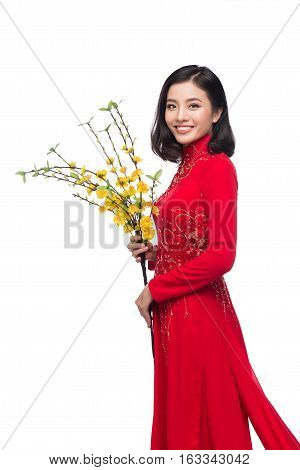 Portrait Of A Beautiful Asian Woman On Traditional Festival Costume Ao Dai Holding Hoa Mai Tree (och