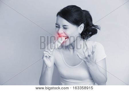 woman have sensitive teeth with ice asian