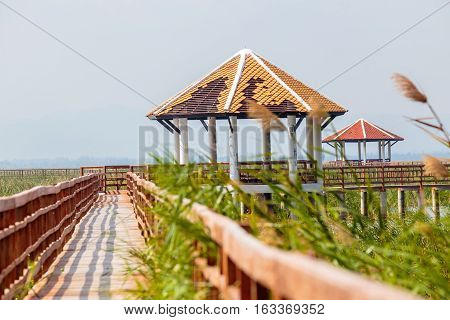 Walkway or walkpath with old pavilion in lake of thailand.