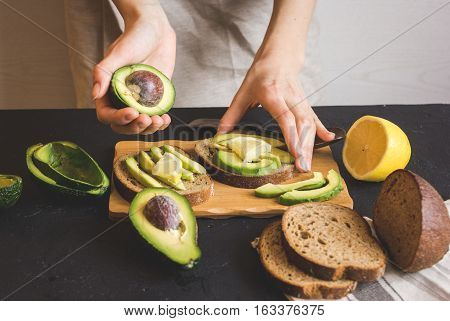 making sandwiches with avocado healthy organic food.