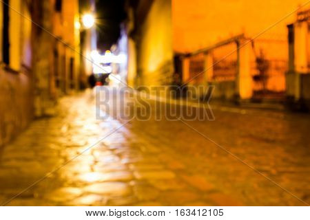 Blurred picture of a stone street taken at night