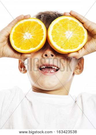 little cute boy with orange fruit double isolated on white smiling without front teeth adorable kid cheerful close up