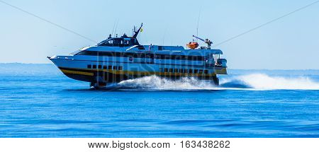 hydrofoil boat runs at full speed on the sea waves