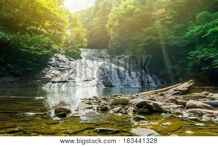 Japan travel concept - beautiful yoro keikoku valley waterfall under dramatic sun glow and morning blue sky in Chiba Prefecture Japan