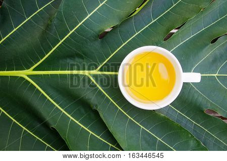 Jasmine tea cup above green leaf, have copy space for your text