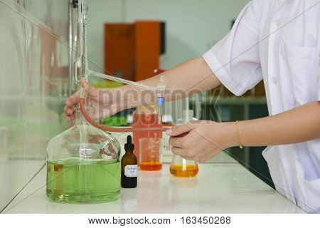 researcher working in a biotechnology lab / biochemical engineer working with microplate in a laboratory experiment