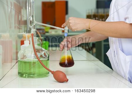 researcher working in a biotechnology lab / biochemical engineer working with microplate in a laboratory experiment