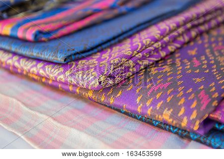 Thailand silk woven by hand which expresses the identity of the people of Thailand are placed overlapping various rashes.