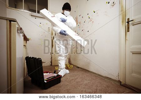 Team of criminologist technicians working on gun packing