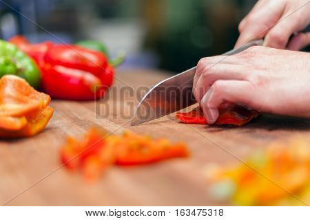 Fresh ecological Bell pepper chopped on cutting board hands stock photo