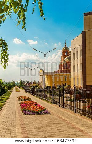 STROITEL BELGOROD REGION RUSSIA - JULE 02 2016: District center in the Belgorod region. Alley overlooking on the city prosecutor's office and current Orthodox church in honor of the New Martyrs and Confessors of Belgorod.