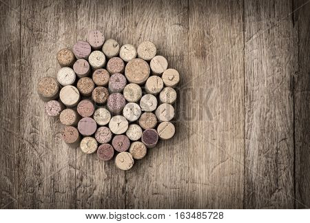 Heap of assorted wine corks on wooden background. with copy space