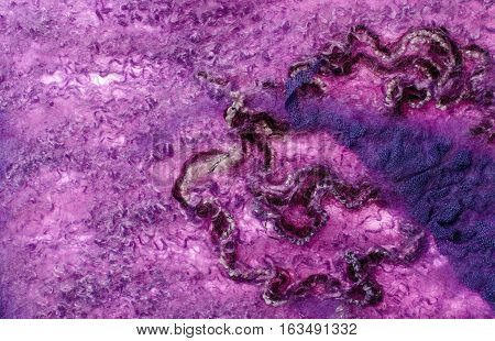 Purple abstract fabric texture of wool with lace and yarn. Craft background