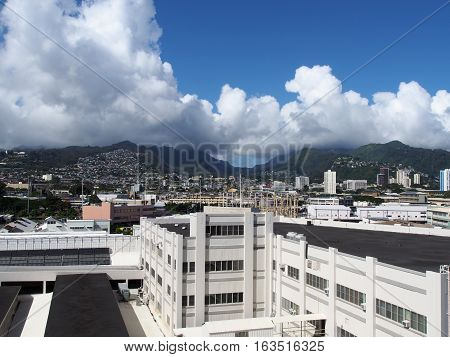 Aerial of Dole Cannery power station and Nuuanu Valley leading to the Mountains on Oahu Hawaii. July 2016. Landscape features Tall buildings Homes and Kamehameha Schools.