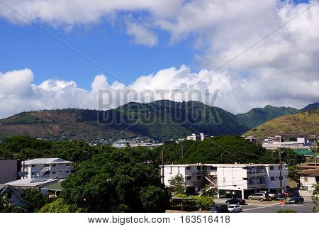 Kapahulu town in Honolulu with homes condos and mountains of Tantalus and St. Louis Heights on a clear day on Oahu Hawaii