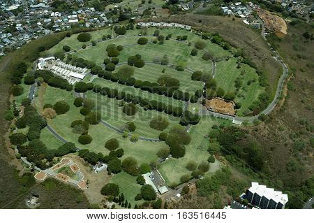 Aerial view of Punchbowl Cemetery or the National Memorial Cemetery of the Pacific with parts under construction which is visited by millions of tourist and island locals every year on the tropical island of Oahu in Honolulu Hawaii USA. April 2016