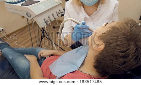 Woman at the dentist clinic office gets dental medical examination and treatment. Odontic and mouth health is important part of modern human life that dentistry help with.
