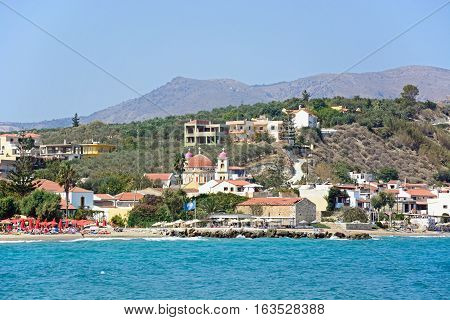 KALYVES, CRETE - SEPTEMBER 16, 2016 - View across the Aegean sea towards the beach and church Kalyves Crete Greece Europe, September 16, 2016.