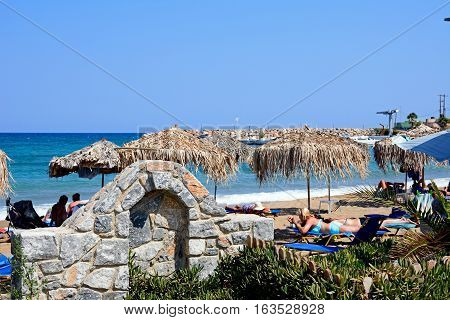 KALYVES, CRETE - SEPTEMBER 16, 2016 - Small wall on the edge of the beach with views towards the Aegean sea Kalyves Crete Greece Europe, September 16, 2016.
